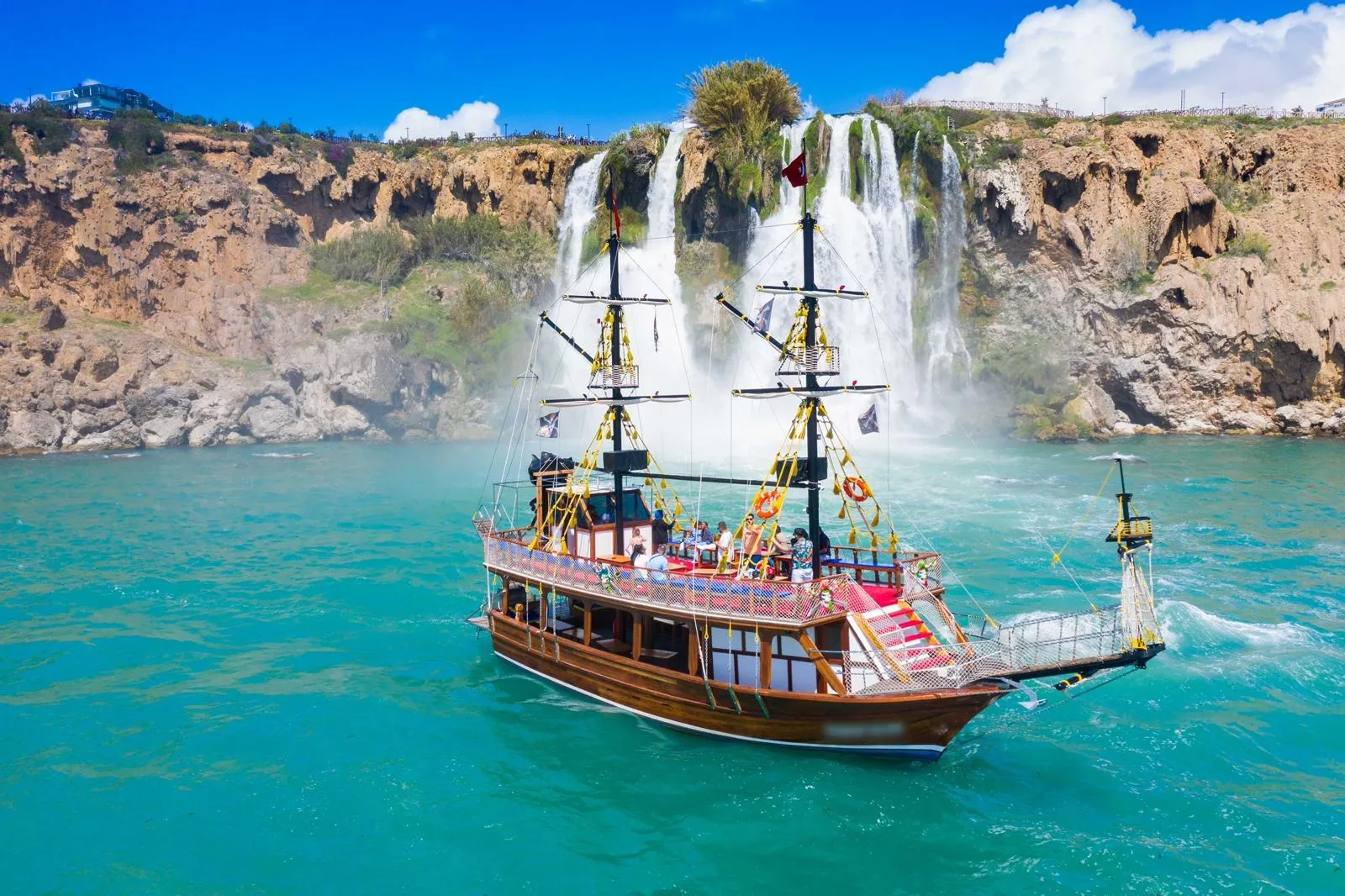 The relax boat in front of the big Düden waterfall near Antalya